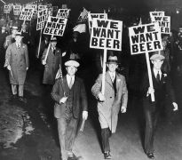 White male demonstrators with "WE WANT BEER" placards