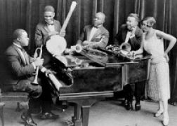 Hot Five musicians around piano